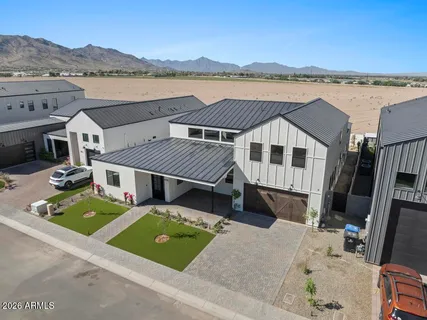 an aerial view of a house with a garden and lake view