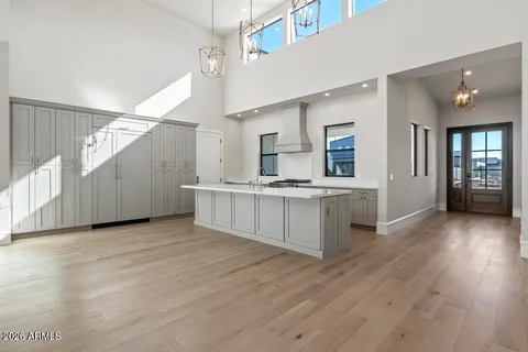 a view of a kitchen with a sink and a large window