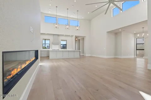 a view of an empty room with a sliding door and wooden floor