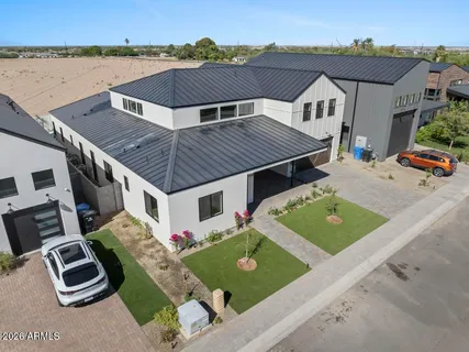 an aerial view of a house with pool and porch