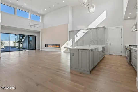 a view of a kitchen with furniture and wooden floor