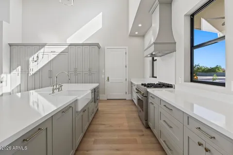 a large kitchen with a sink and stove