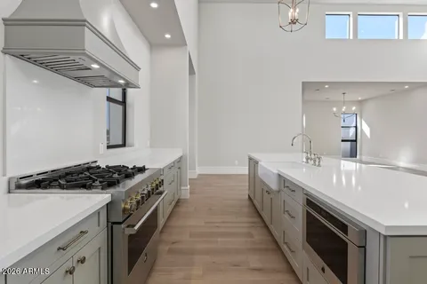 a kitchen with stainless steel appliances a sink dishwasher stove and oven