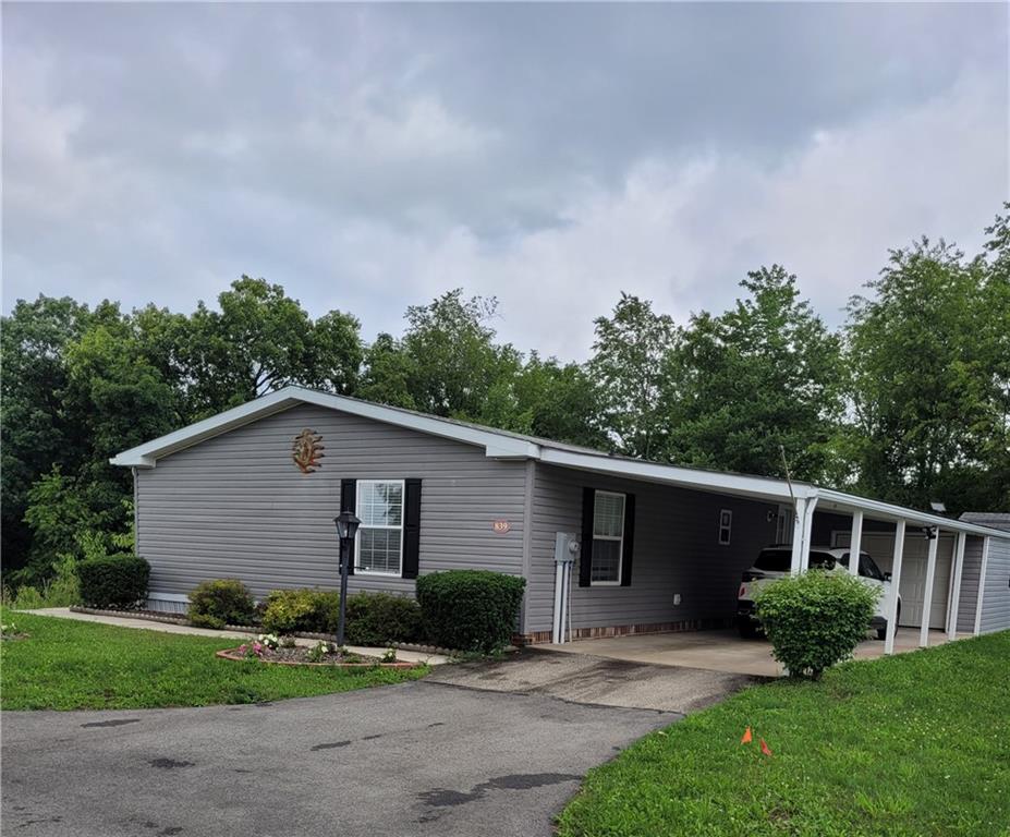 839 Hummingbird Lane Apollo, PA 15613 - Photo 1 of 26 a view of a yard in front of a house with plants and large tree