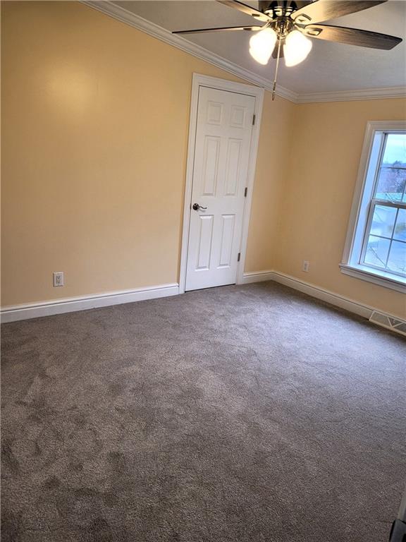 839 Hummingbird Lane Apollo, PA 15613 - Photo 13 of 26 an empty room with a chandelier fan and windows