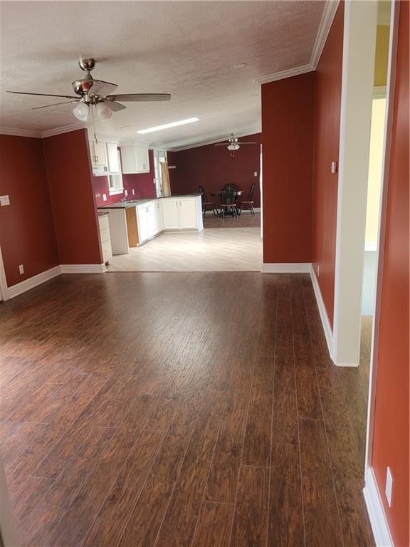 839 Hummingbird Lane Apollo, PA 15613 - Photo 20 of 26 an empty room with wooden floor and a kitchen