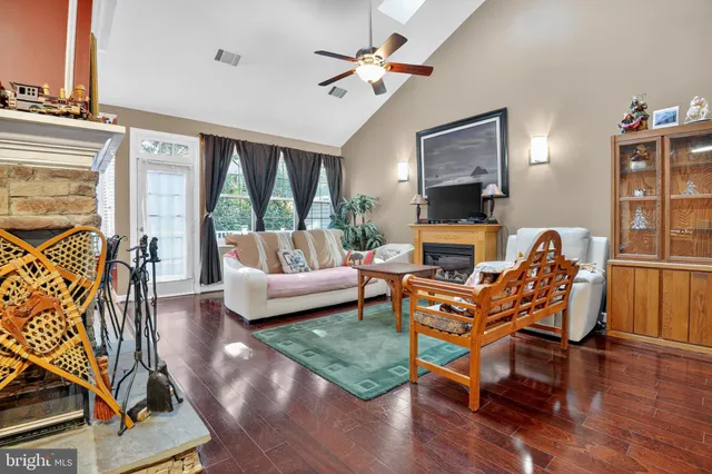 a living room with patio furniture and a fireplace