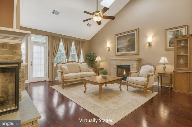 a living room with furniture a fireplace and a large window