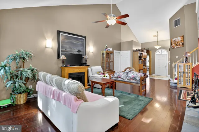 a living room with furniture potted plant and a chandelier