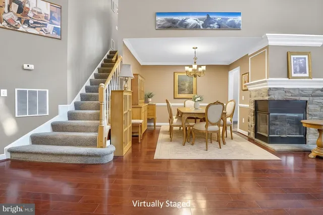 a view of entryway livingroom and hall with wooden floor