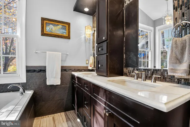a bathroom with a granite countertop sink a toilet and shower