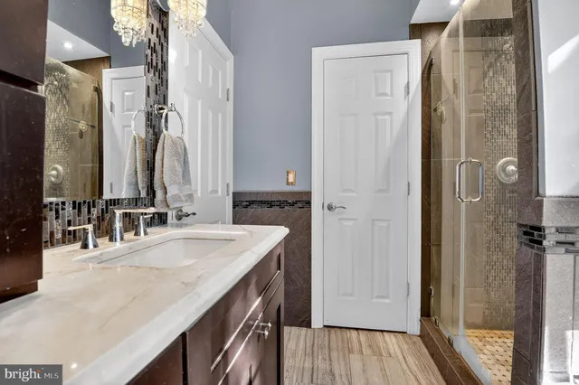 a bathroom with a sink a granite counter and a mirror