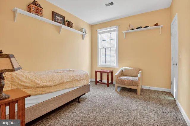 walk in closet with clothes and shoes