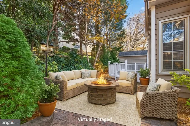 a view of a patio with couches chairs and potted plants