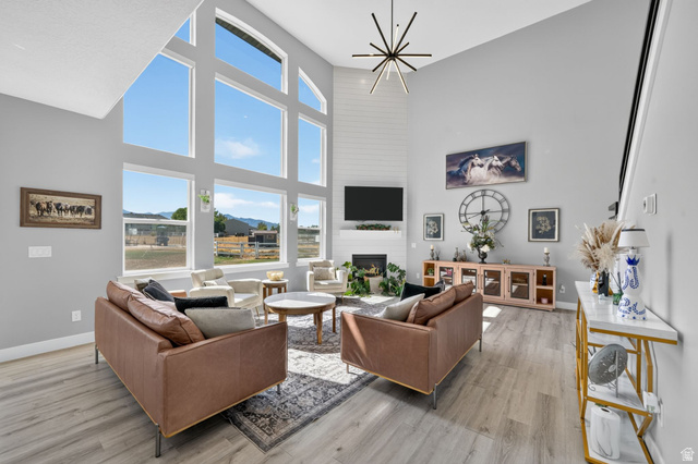 3644 Spiral Springs Road Tooele, UT 84074 - Photo 4 of 41 Open-concept living area featuring high ceilings, wood-finish flooring, a contemporary staircase and large windows