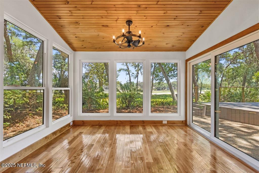 22 Belted Kingfisher Road Fernandina Beach, FL 32034 - Photo 11 of 70 a view of an empty room with wooden floor and a window