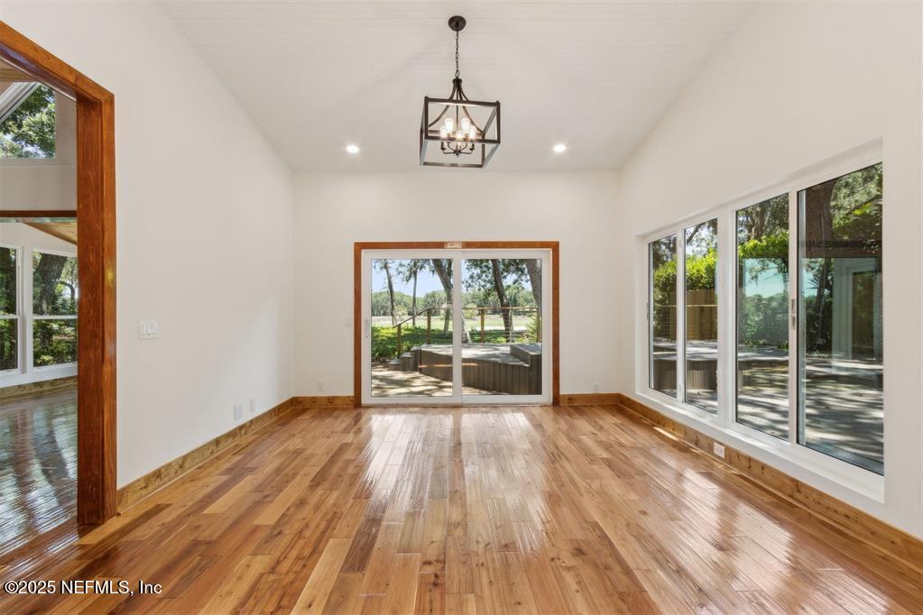 22 Belted Kingfisher Road Fernandina Beach, FL 32034 - Photo 19 of 70 a view of an empty room with wooden floor and a window