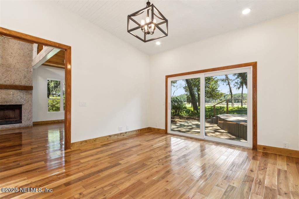 22 Belted Kingfisher Road Fernandina Beach, FL 32034 - Photo 20 of 70 a view of an empty room with wooden floor and a window