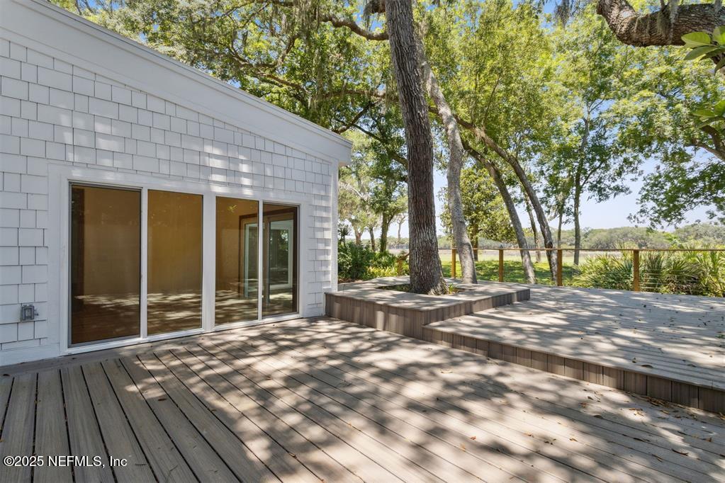 22 Belted Kingfisher Road Fernandina Beach, FL 32034 - Photo 21 of 70 a view of backyard with large trees and wooden fence