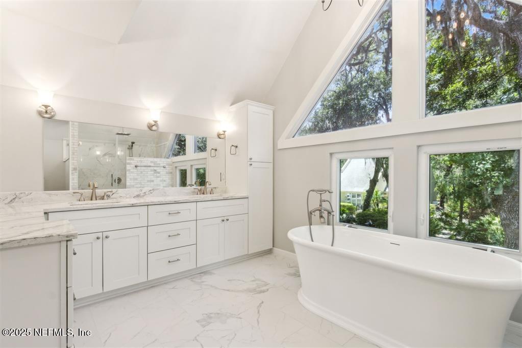 22 Belted Kingfisher Road Fernandina Beach, FL 32034 - Photo 29 of 70 a bathroom with a granite countertop sink mirror and a bathtub
