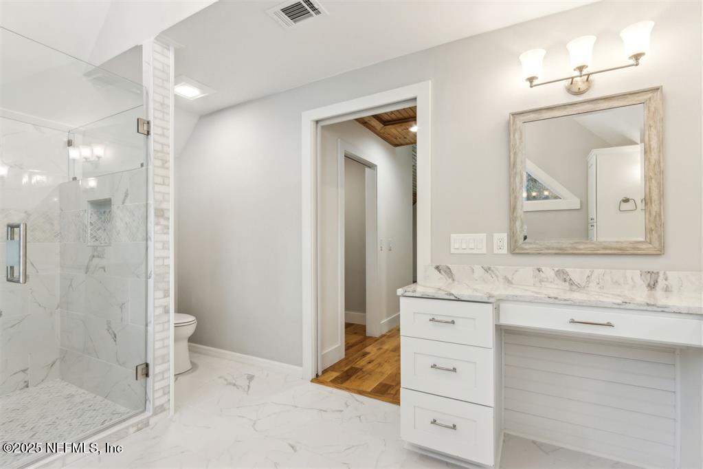 22 Belted Kingfisher Road Fernandina Beach, FL 32034 - Photo 32 of 70 a bathroom with a double vanity sink mirror and shower