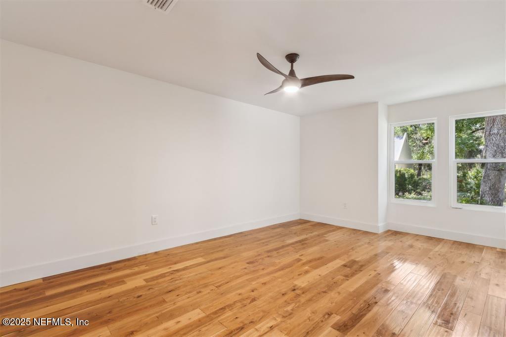 22 Belted Kingfisher Road Fernandina Beach, FL 32034 - Photo 34 of 70 wooden floor in an empty room with a window