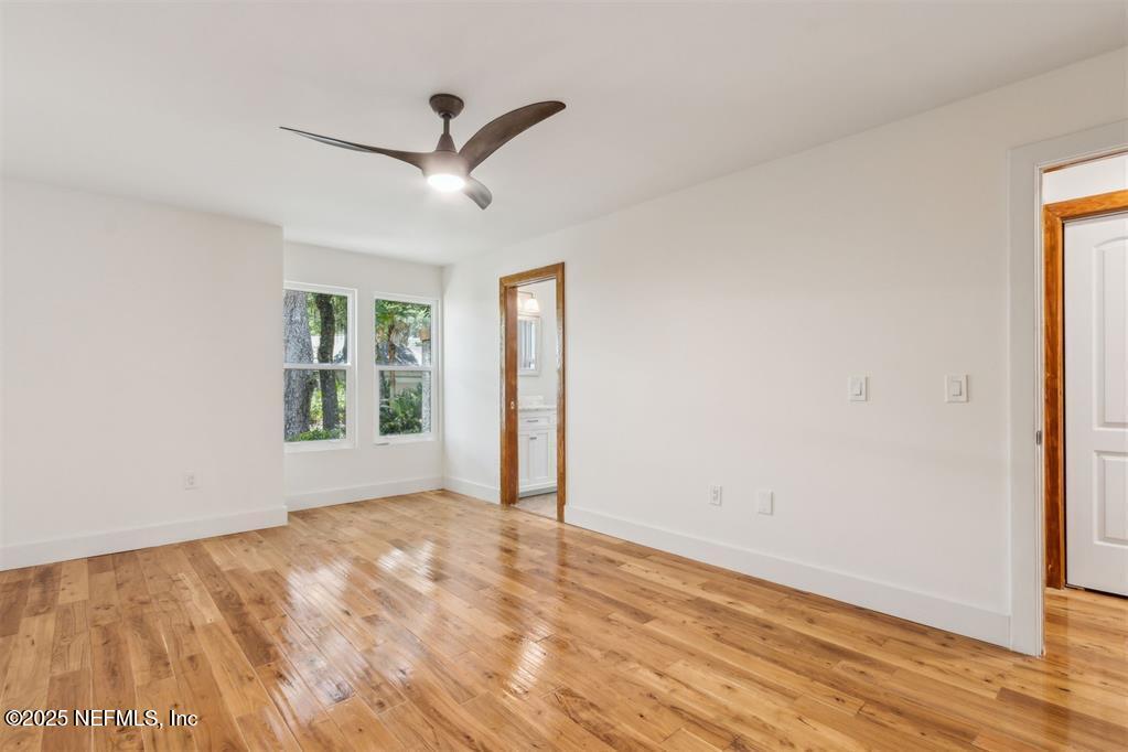 22 Belted Kingfisher Road Fernandina Beach, FL 32034 - Photo 36 of 70 a view of empty room with wooden floor and fan