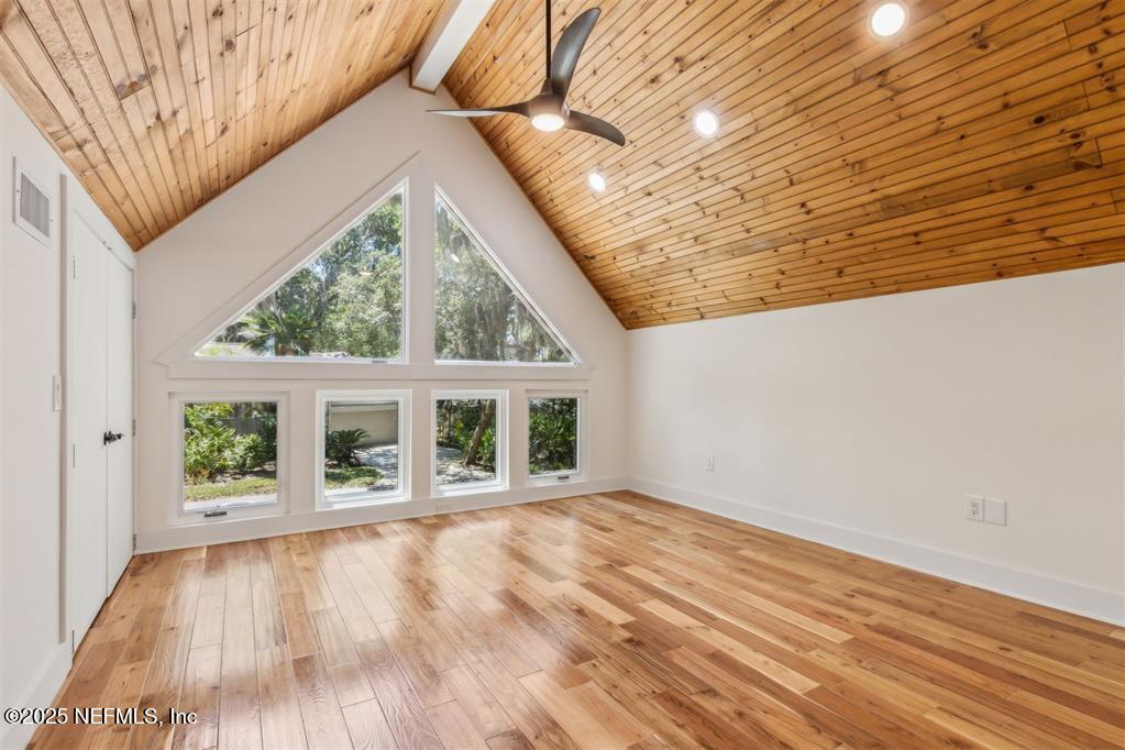 22 Belted Kingfisher Road Fernandina Beach, FL 32034 - Photo 39 of 70 an empty room with wooden floor and windows