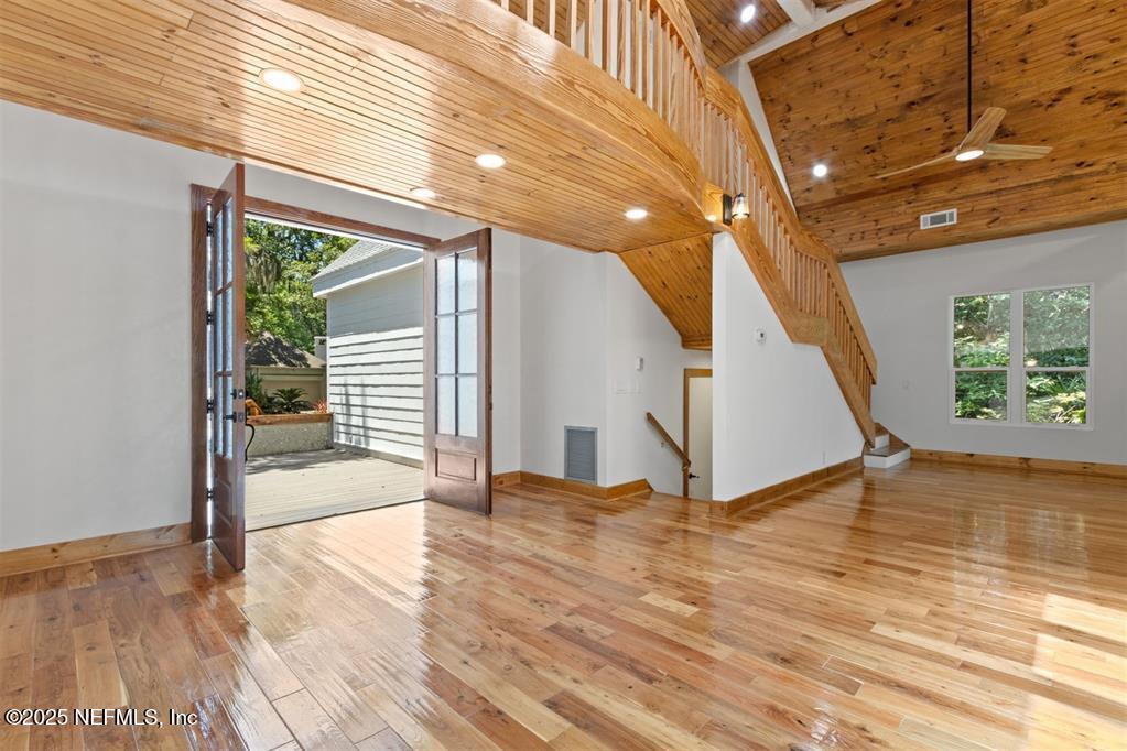 22 Belted Kingfisher Road Fernandina Beach, FL 32034 - Photo 6 of 70 a view of an empty room with wooden floor and stairs