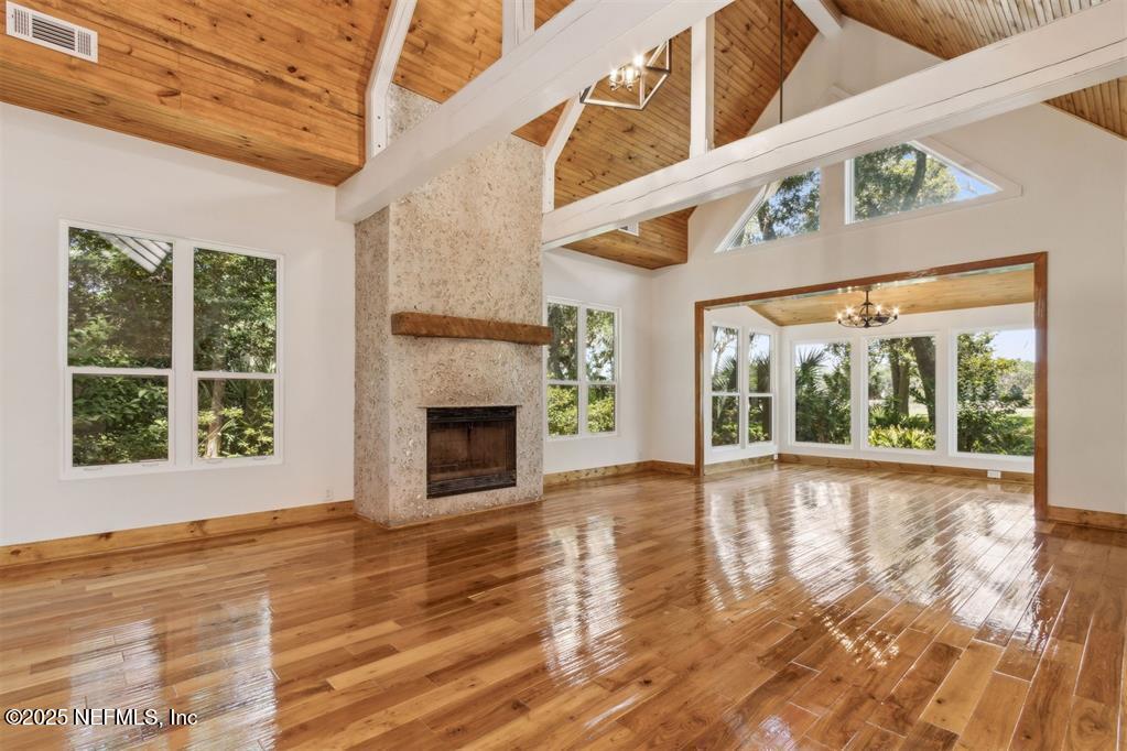 22 Belted Kingfisher Road Fernandina Beach, FL 32034 - Photo 9 of 70 a view of an empty room with wooden floor and a window