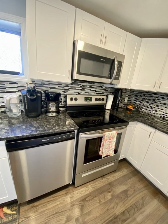 3 Leland Hill Road Sutton, MA 01590 - Photo 11 of 38 a kitchen with stainless steel appliances granite countertop a stove a microwave and a sink