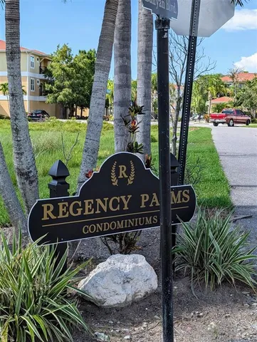 a view of a street with potted plants and sign board