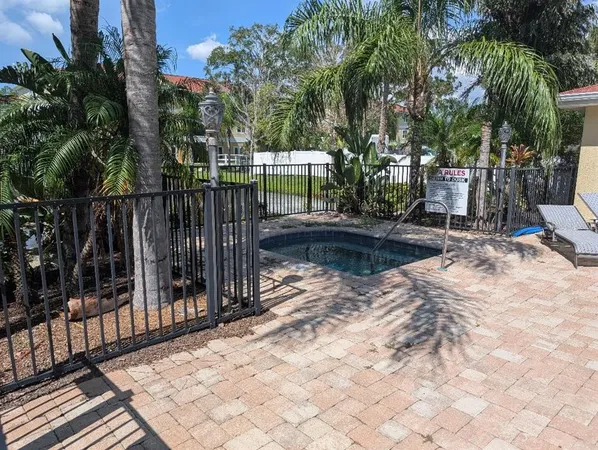 a view of backyard with wooden fence and trees