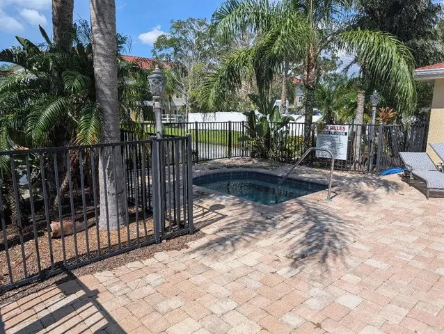 a view of backyard with wooden fence and trees
