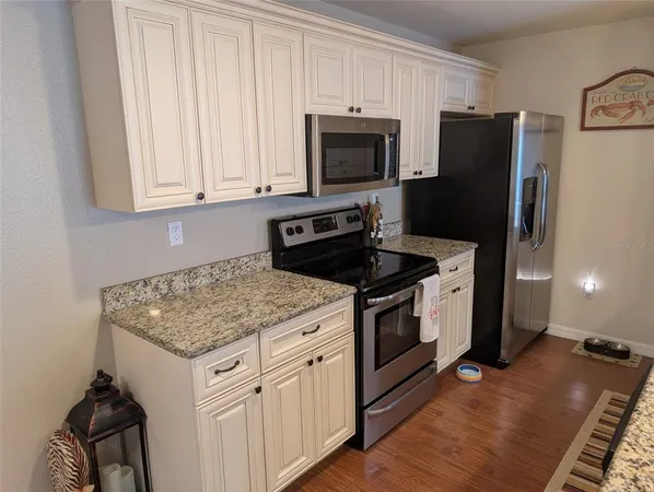 a kitchen with a stove microwave and refrigerator