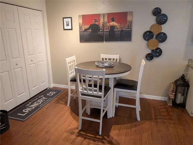 a view of a dining room with furniture and wooden floor
