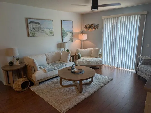 a living room with furniture and a wooden floor