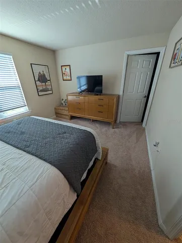 a bedroom with a bed and dresser