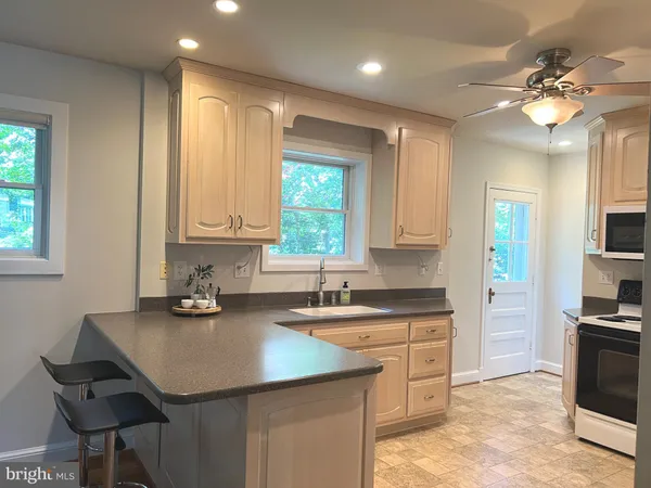 a kitchen with a sink cabinets and window