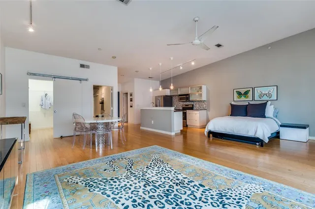 a kitchen with stainless steel appliances kitchen island granite countertop a stove and a refrigerator