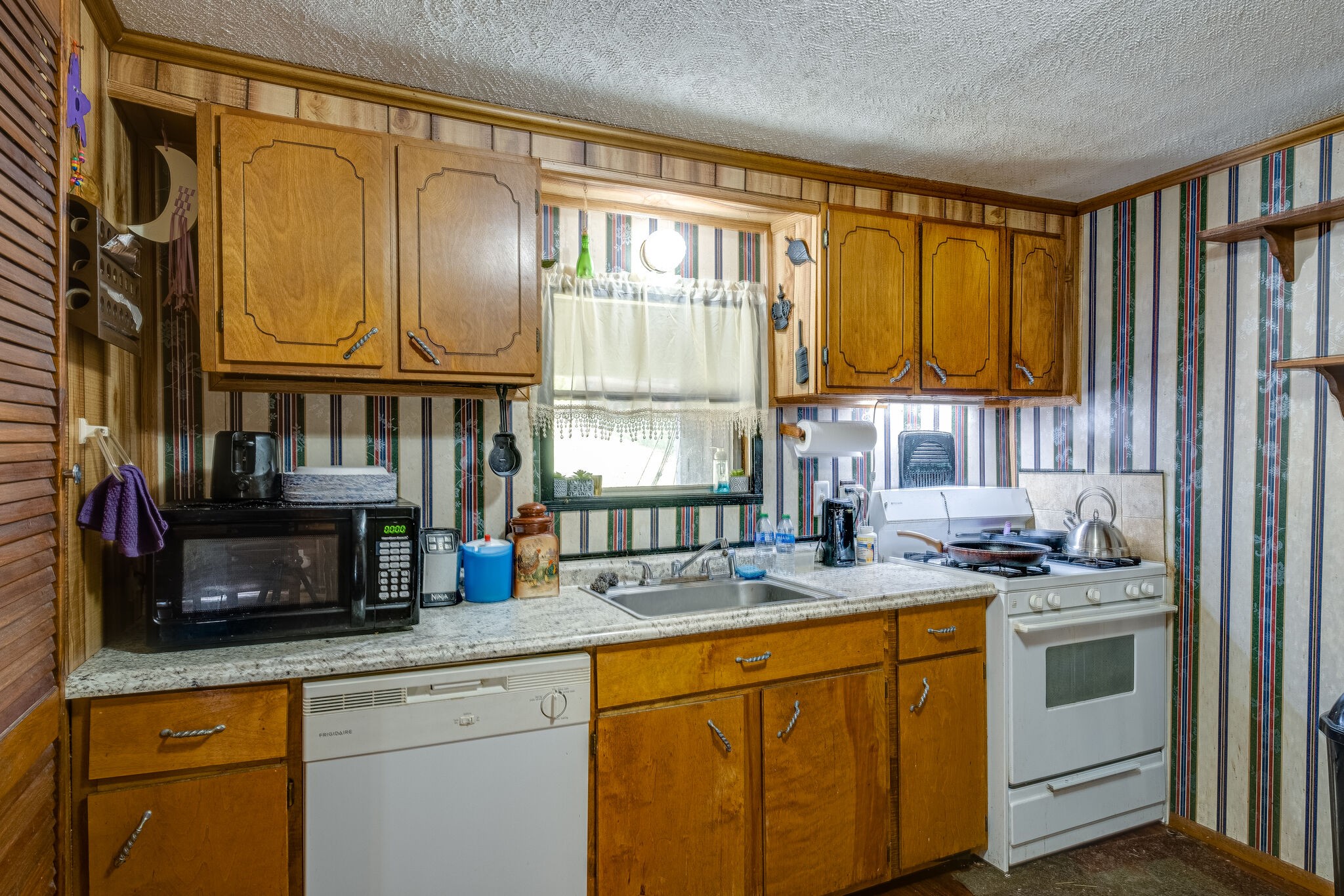 1889 Ford Road Lebanon, TN 37087 - Photo 7 of 18 a kitchen with stainless steel appliances granite countertop a sink a stove and a refrigerator