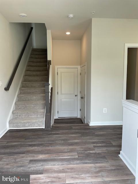 8235 Front Loop Rockville, MD 20855 - Photo 2 of 22 a view of a hallway with wooden floor and staircase