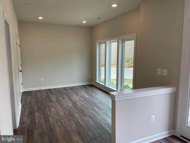 8235 Front Loop Rockville, MD 20855 - Photo 4 of 22 a view of an empty room with wooden floor and a window