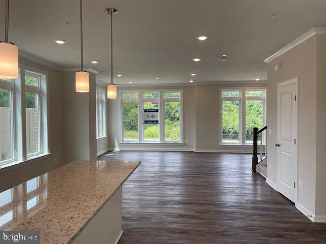 8235 Front Loop Rockville, MD 20855 - Photo 7 of 22 a view of an empty room with wooden floor and a window