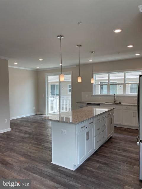 8235 Front Loop Rockville, MD 20855 - Photo 8 of 22 a kitchen with granite countertop wooden floors and white cabinets