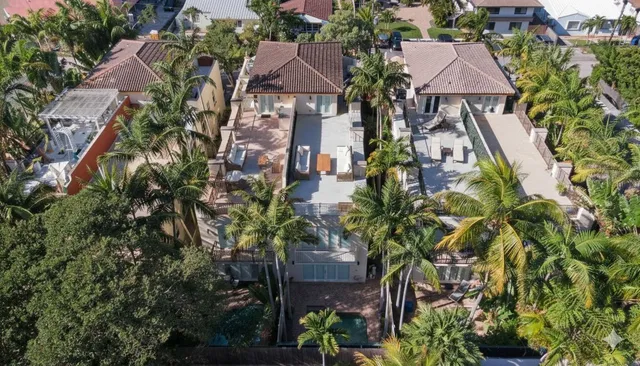 an aerial view of multiple houses with yard