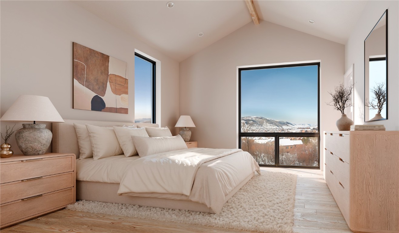 2075 Walton Creek Road, Unit 2B Steamboat Springs, CO 80487 - Photo 4 of 8 a bedroom with a large bed and a painting on the wall