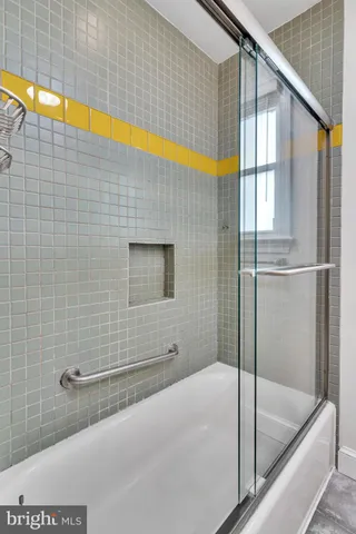 a bathroom with a bathtub and shower