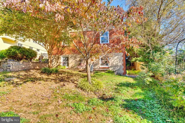 a backyard of a house with large trees