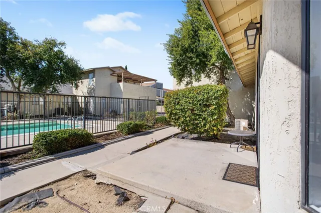 a view of a patio with couches and potted plants